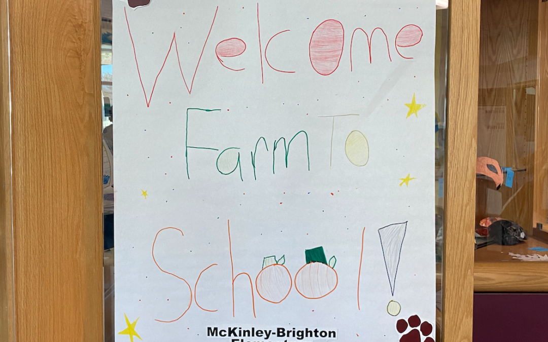 A sign on white poster paper in children's handwriting reads "Welcome Farm to School!"